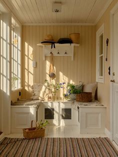 the sun shines through the windows into a room with wood paneling and white walls