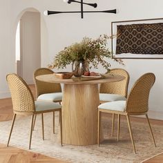 a dining table with four chairs around it