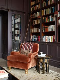 a living room filled with lots of books and furniture