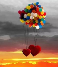 two heart shaped balloons floating in the air