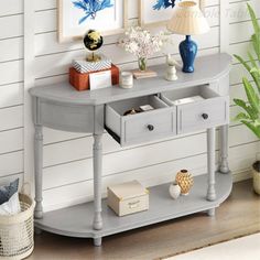 a grey table with two drawers and a lamp