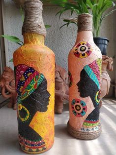 two vases made to look like bottles with african women painted on them