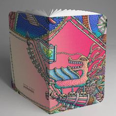 an open book with colorful designs on it