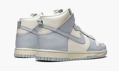 The Women’s Nike Dunk High “Football Grey” is the women’s sizing of the all-time classic high-top shoe that was released by Nike in early January 2021.  The “Football Grey” doesn’t have any ties to a specific football team, but instead references the shade of grey used on its design.  Along with the interesting shade, an elegant mixture of Sail and Pale Ivory combine to form a stately look for the Nike Dunk High.  A cream colored leather appears on the perforated toe, mid-panel, collar, and heel High Top Shoe, Nike Dunk High, Nike Brand, Dunk High, Womens Football, Grey Shoes, Colored Leather, Black Metallic, Nike Dunk