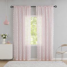 the pink curtains in this room are very feminine and chic, but they're not