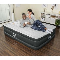 a man and woman laying on an inflatable mattress