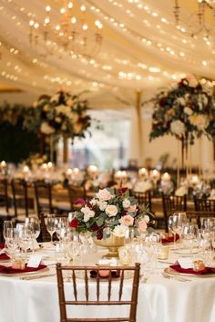 the tables are set with white linens and red napkins for an elegant wedding reception