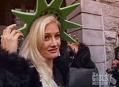 a woman wearing a statue of liberty hat on top of her head