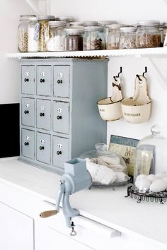 an organized kitchen with lots of jars on the shelves