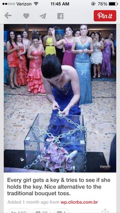 a woman in a blue dress standing over a glass box filled with flowers and chains