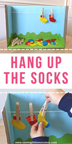 a box with clothes pins hanging from it and the words hang up the socks above