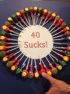 there is a circle made out of candy sticks with the words 40 sucks on it