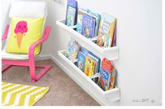 a child's book shelf with books on it and an ice cream cone pillow