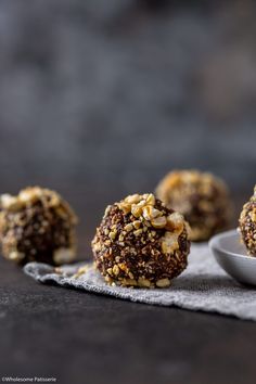 three balls of food sitting on top of a table next to a spoon and napkin