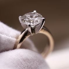 a close up view of a ring with a diamond on it's center stone