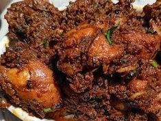 some food is in a white bowl on a table and it looks like fried meat