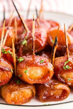 small appetizers with toothpicks are arranged on a plate