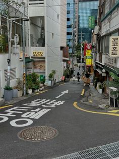 an empty city street with buildings in the background