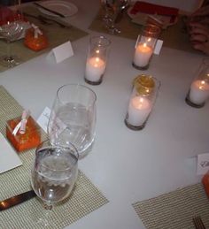 the table is set with candles and place settings