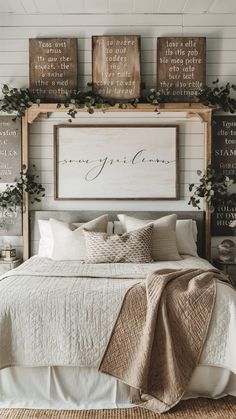 a bed with white sheets and pillows next to wooden signs on the wall above it