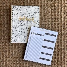 two notebooks sitting next to each other on top of a carpeted floor with gold lettering