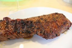 a piece of meat sitting on top of a white plate