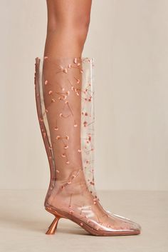 An Italian vinyl boot with real pressed flowers accentuated by a satin toe cap and satin heel. — Italian vinyl — Real pressed flowers — Satin toe cap, footbed, and heel — Zip opening Clear Boots, Icon Clothing, Evening Flats, Sandal Platform, Swimming Bag, Satin Heels, Candle Collection, Boot Accessories, Kids Sandals