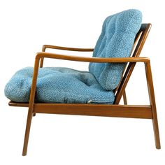 a wooden chair with a blue cushion on it