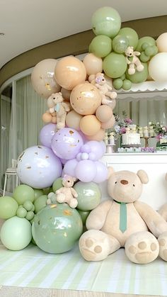 there are many balloons and teddy bears on the table