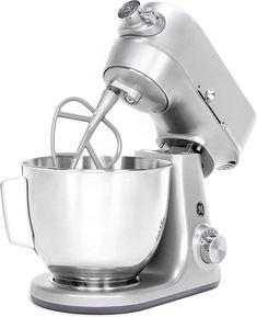 an electric mixer with a metal bowl on it's side and a whisk attachment in the middle