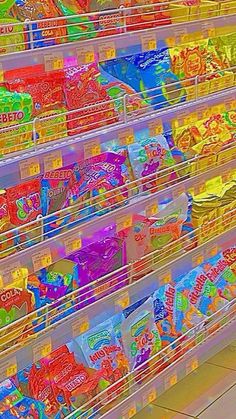 many plastic bins filled with different types of candy in a store or convenience section