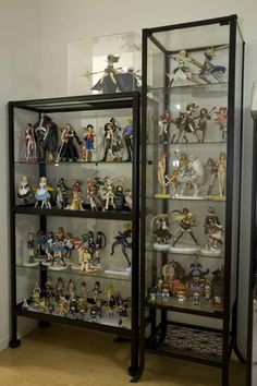 a display case filled with action figures and figurines on top of wooden floors