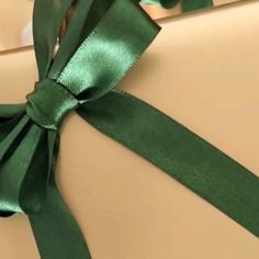 a close up of a green ribbon on a present box