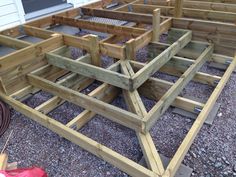 several wooden benches sitting on top of gravel