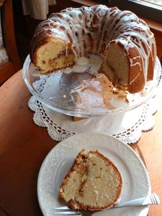 a bundt cake on a plate with a slice cut out and ready to be eaten