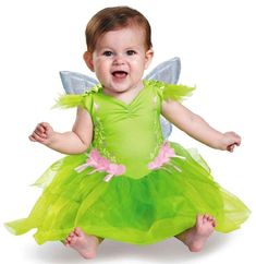 a baby dressed in a green fairy costume