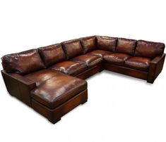 a brown leather sectional sofa sitting on top of a white floor