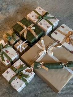 many wrapped presents sitting on the floor together