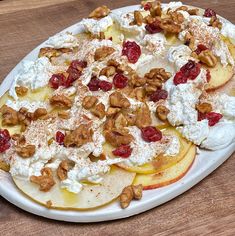 a white plate topped with fruit and whipped cream