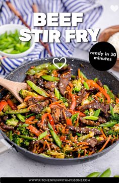 beef stir fry in a skillet with broccoli and carrots on the side