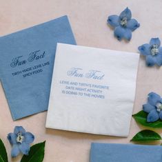 two napkins with blue flowers next to each other