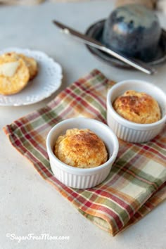 three small white bowls filled with food on top of a table