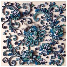 an intricately designed wall panel with blue flowers and swirls on white background,