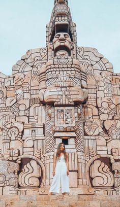 a woman standing in front of an intricately designed building