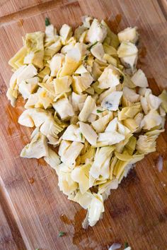 chopped up food sitting on top of a wooden cutting board