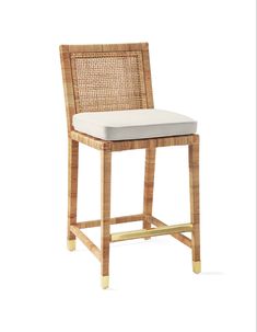 a wicker bar stool with a white cushion on the seat and backrests