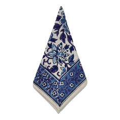 a blue and white napkin with an intricate design on the front, sitting on a white surface