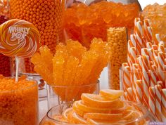 there are many candies in the glass vases