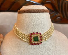 Discover timeless elegance with this Gold Plated Bollywood Necklace Choker Set. Adorned with green pearls, dazzling CZ stones, elegant white pearls, and striking ruby stones in a traditional Jadau Kundan setting, this set is perfect for adding a touch of glamour to any occasion. Handcrafted with care, each piece showcases intricate craftsmanship and a luxurious gold plating finish. Whether for a wedding, party, or special event, this set promises to elevate your style with its vibrant colors and Green Kundan Pearl Necklace For Wedding, Green Round Gemstone Kundan Necklace, Bollywood Style Green Kundan Choker, Green Kundan Bollywood Choker, Traditional Green Kundan Necklace, Luxury, Kundan Jewellery Set, Green Pearls, Ruby Stone, Kundan Jewellery