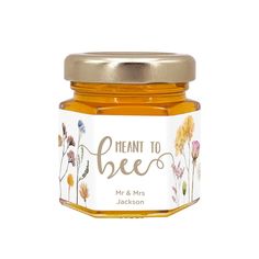 a jar of honey with the words meant to bee on it and wildflowers